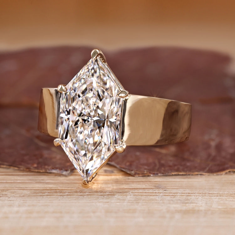 Solitaire diamond ring with six claw prong setting.
