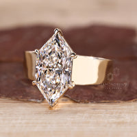 Basket setting ring with marquise center stone.
