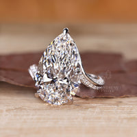 Pear diamond ring with bypass setting.
