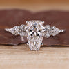 Coffin cut engagement ring with kite and round side stones.