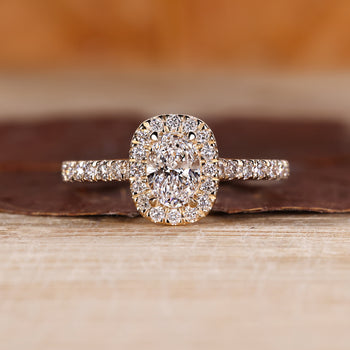 Oval cut diamond ring with halo setting.
