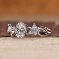 Custom diamond ring with oval center and side stone accents.
