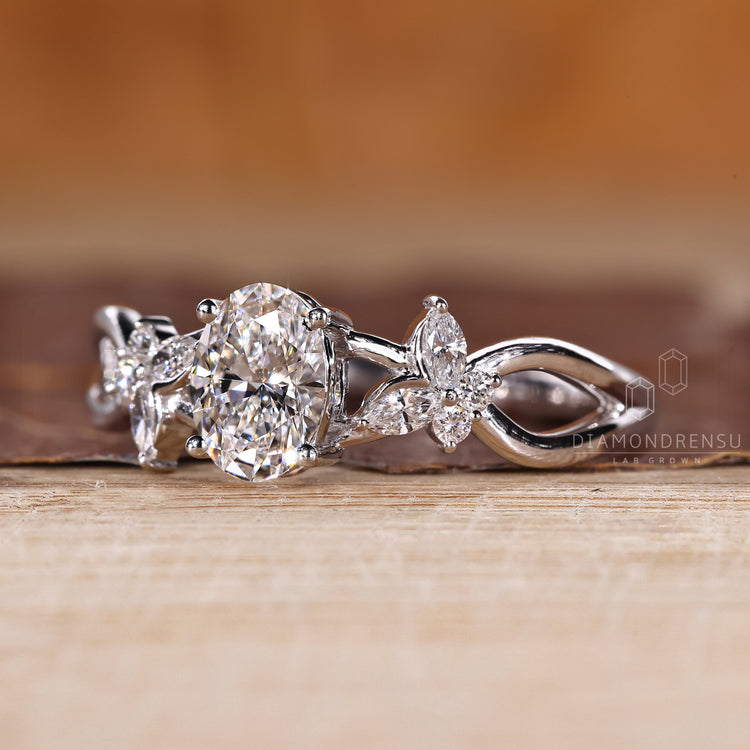 Custom diamond ring with oval center and side stone accents.
