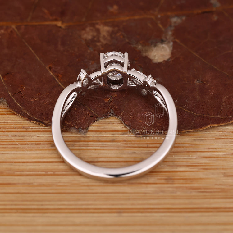 Custom engagement ring with twisted shank and oval diamond centerpiece.
