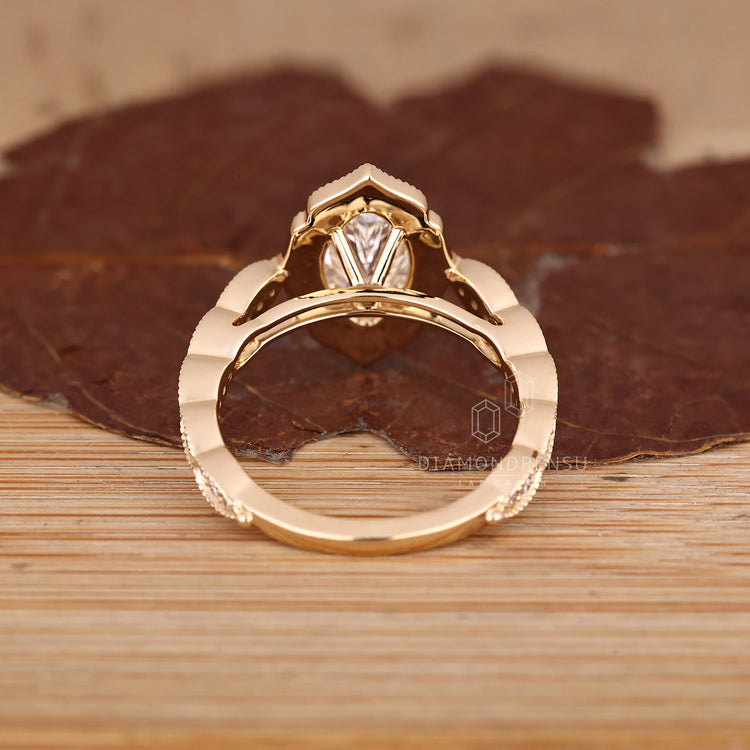 Marquise Diamond Ring With Six Prong Mount And Round Halo.