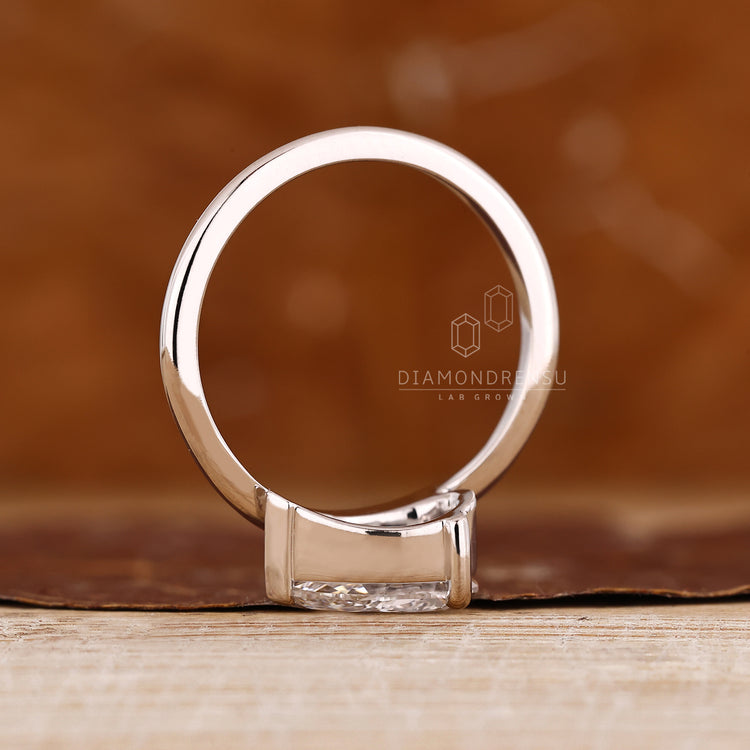 Lab grown pear diamond ring in V shaped prong east west solitaire design.
