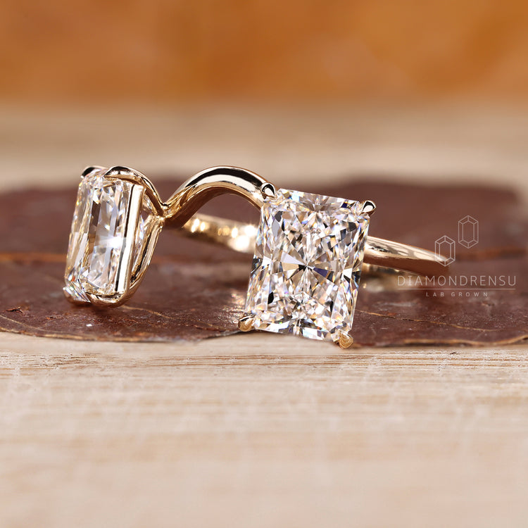 Claw prong ring highlighting radiant cut diamonds and secure setting.
