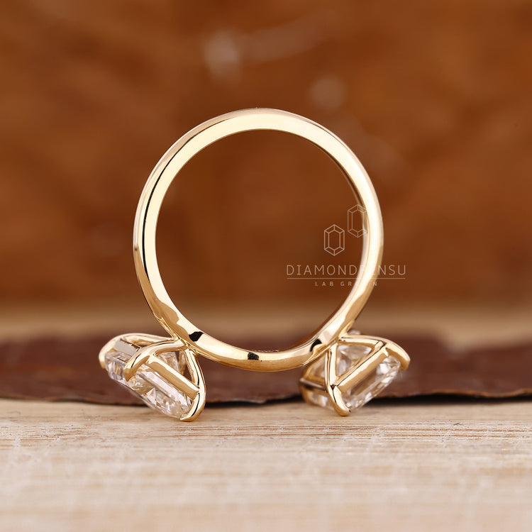 Handmade jewelry with curvy shaped radiant cut two stone ring.
