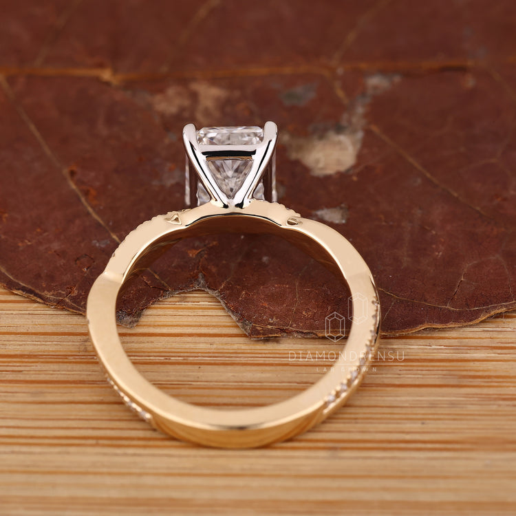 Diamondrensu handmade ring with radiant cut center and twisted shank accents.
