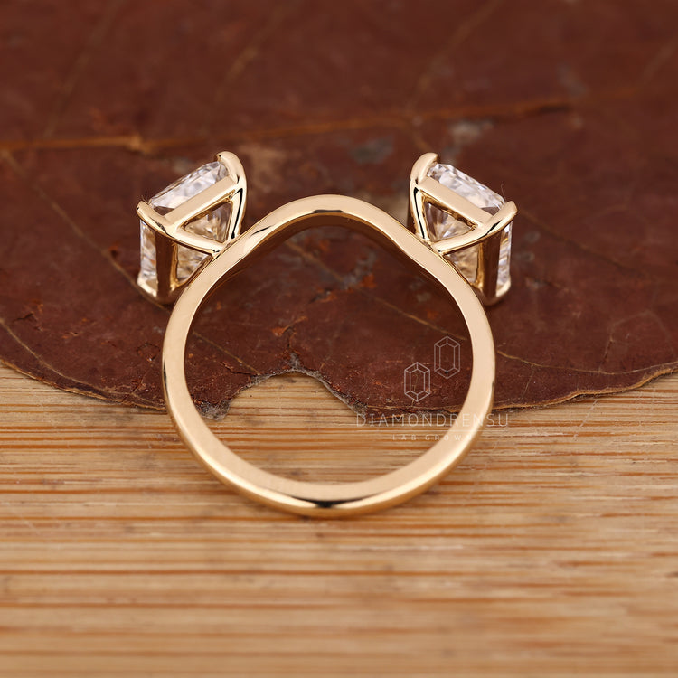 Yellow gold radiant cut engagement ring with stackable band design.
