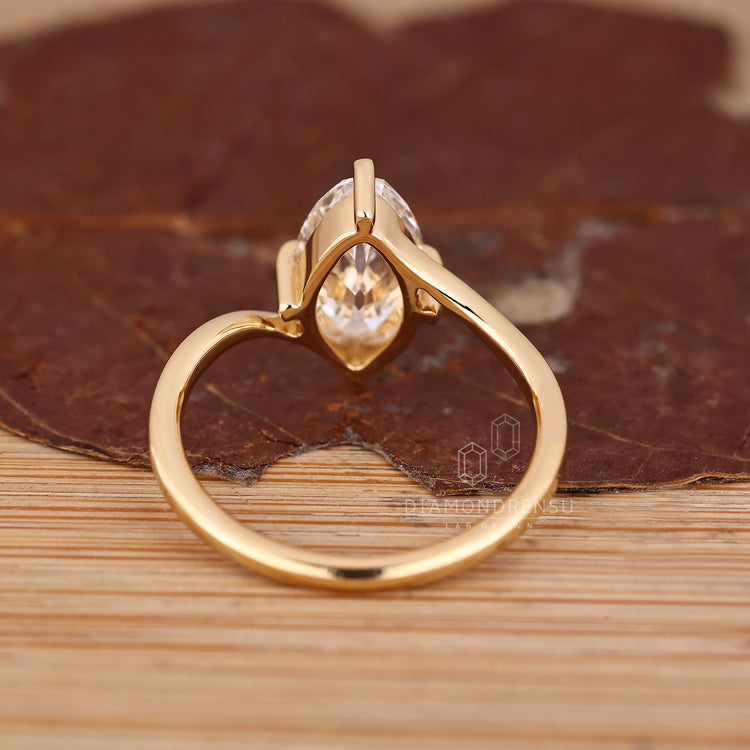 IGI certified marquise diamond in handmade bypass ring.