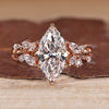 Marquise cut diamond ring with marquise and round side stones.