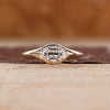Old mine cushion cut diamond ring in east to west solitaire setting.
