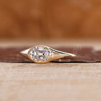 East to west solitaire ring featuring lab grown cushion cut diamond.
