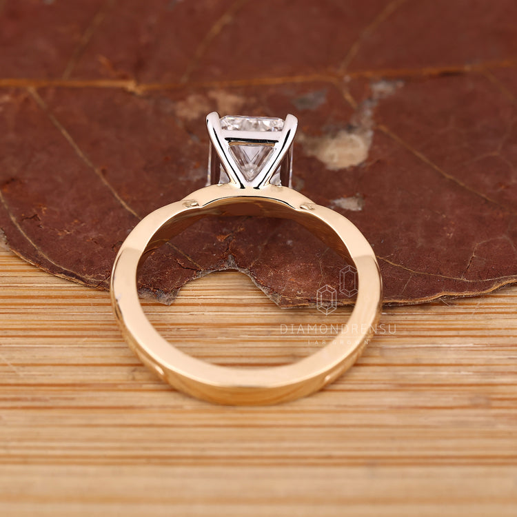 Handmade jewelry featuring radiant cut diamond and two tone shank.
