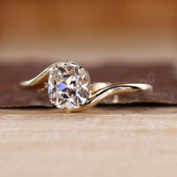 Custom diamond ring with old European cut and bypass design.
