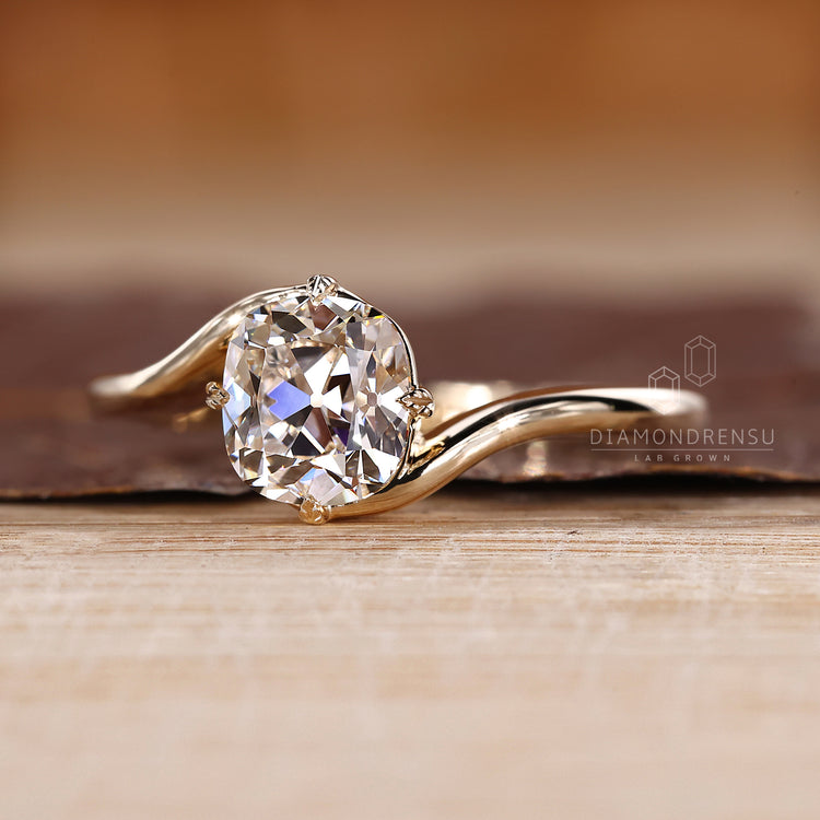 Custom diamond ring with old European cut and bypass design.
