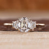 Old mine cushion cut diamond with trapezoid side stones.