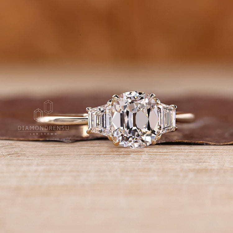 Cushion old mine cut diamond with trapezoid side stones by Diamondrensu.