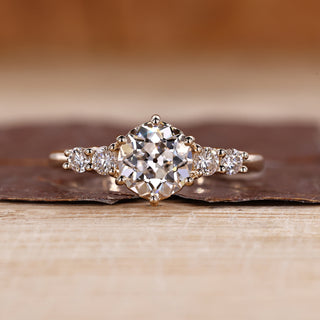 Old european cut ring with round diamond and five stone design.