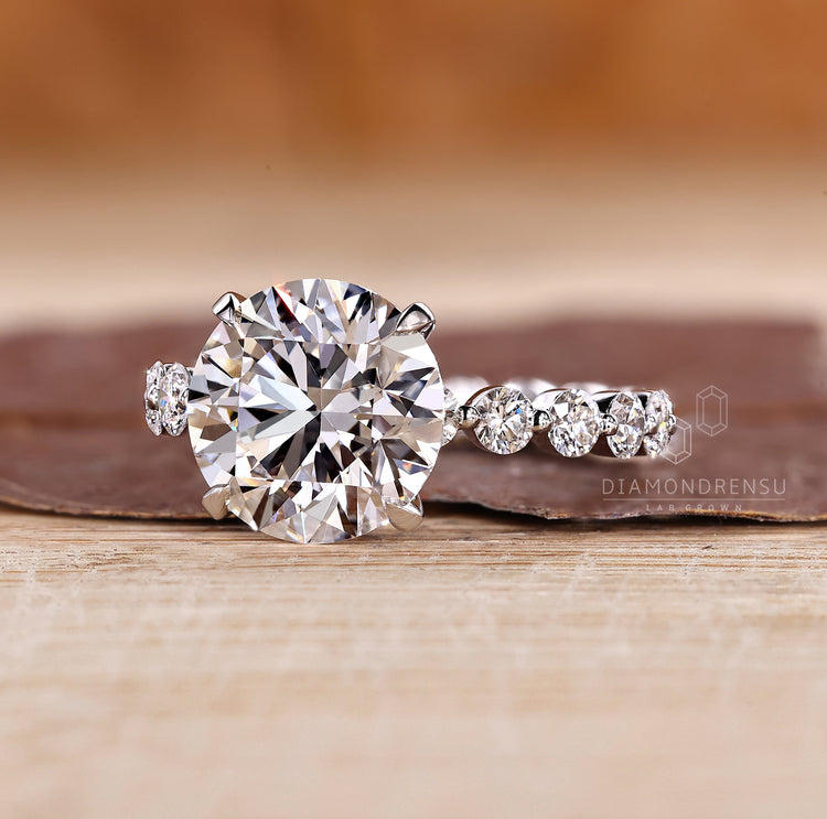 Round diamond ring with bubble pave band.
