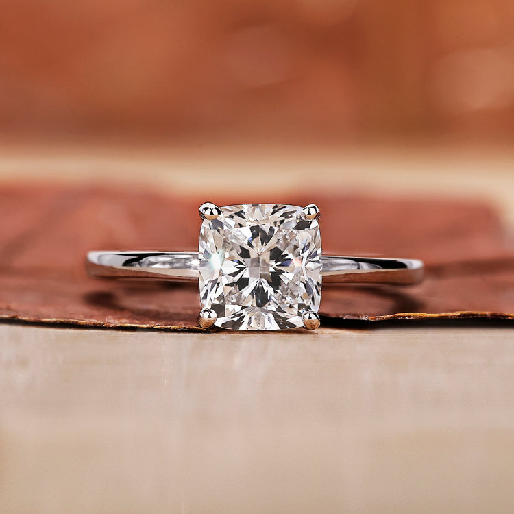 A cushion cut engagement ring with a classic and elegant design in a soft velvet box.

