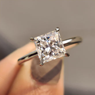 Princess cut engagement ring with a hidden halo setting.
