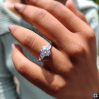 Baguette side stones accent a stunning round moissanite.
