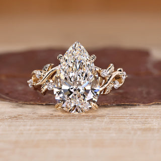 Pear shaped diamond ring with nature inspired design.
