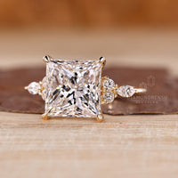 Princess cut engagement ring with tapered shank design.
