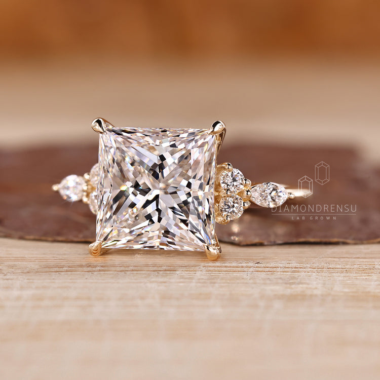 Princess cut engagement ring with tapered shank design.
