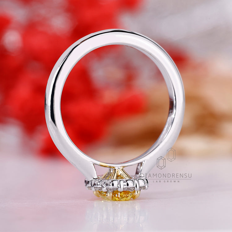 Diamondrensu engagement ring with center oval diamond and four claw setting.
