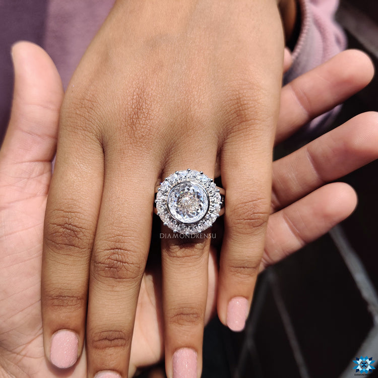 Handmade ring featuring a trillion cut moissanite set in a stunning bezel halo design.