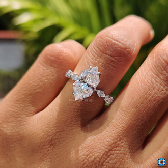 White gold engagement ring with marquise moissanite side stones.
