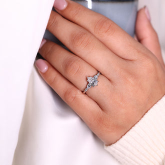 Pear and round side stone diamond engagement ring.
