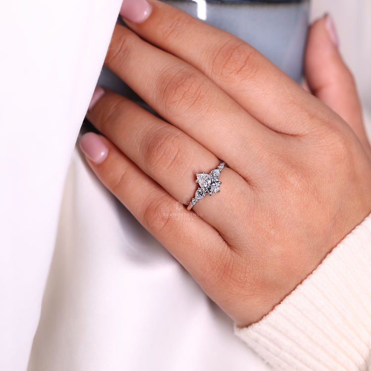 Pear and round side stone diamond engagement ring.
