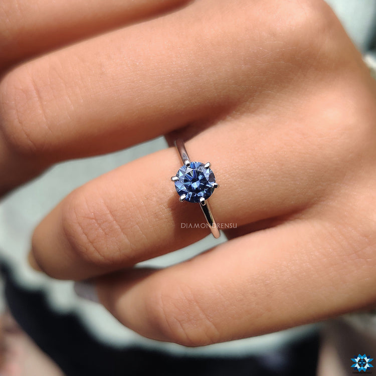 Minimalist ring featuring a round cut moissanite.
