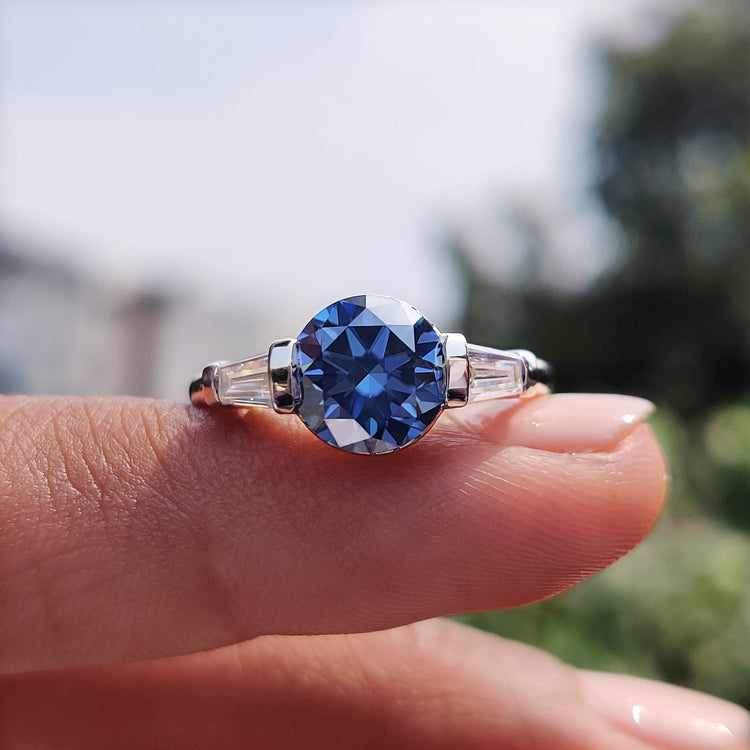 Three stone moissanite ring in white gold.