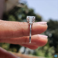 Moissanite engagement ring with custom design and four stone setting.