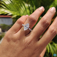 Round and marquise moissanite side stones engagement ring.