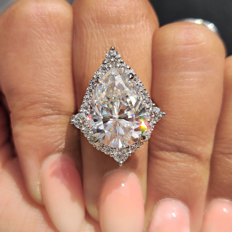Halo engagement ring featuring a stunning round moissanite center stone.
