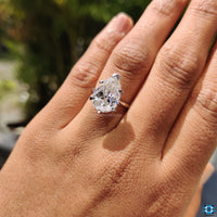 V prong setting ring designed to hold a pear cut moissanite securely.
