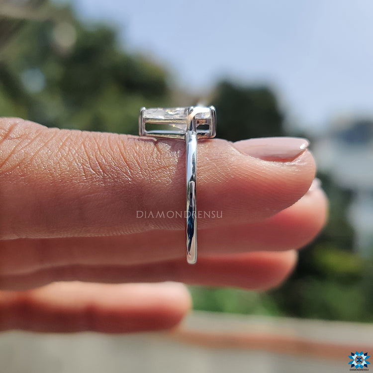 Moissanite solitaire ring designed with a prong setting in a sleek white gold band.
