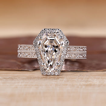 Coffin cut engagement ring with round cut halo and double band.