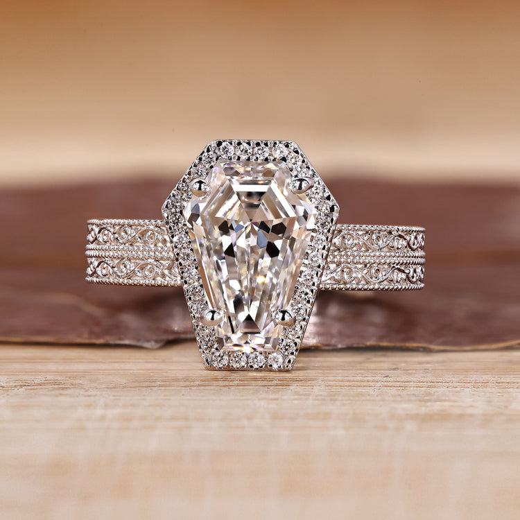 Coffin cut engagement ring with round cut halo and double band.