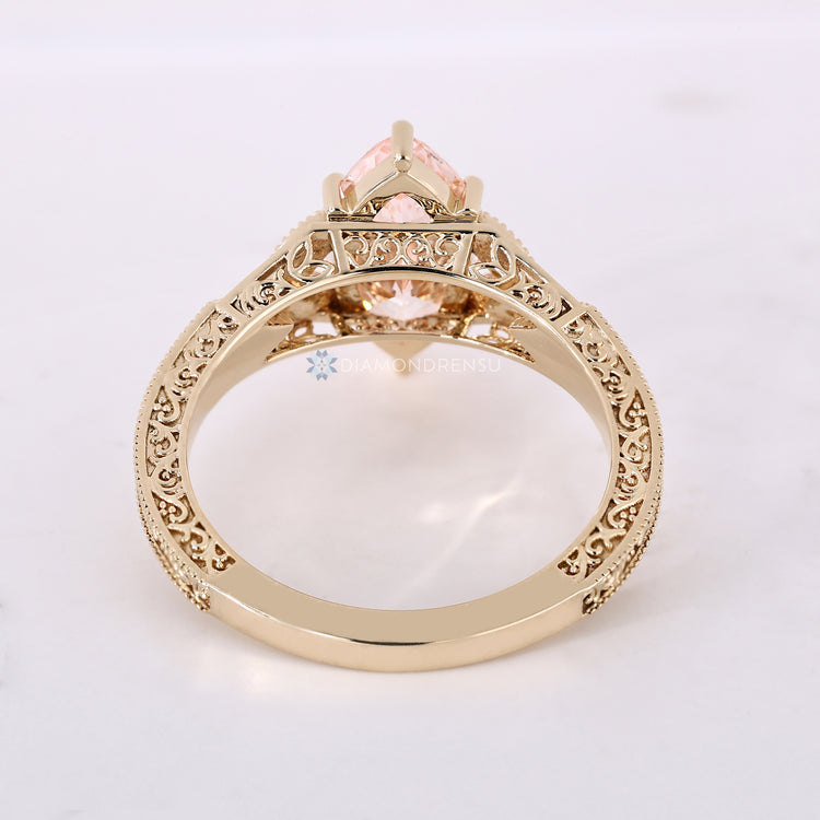 Six claw prong setting for a pink marquise diamond ring.