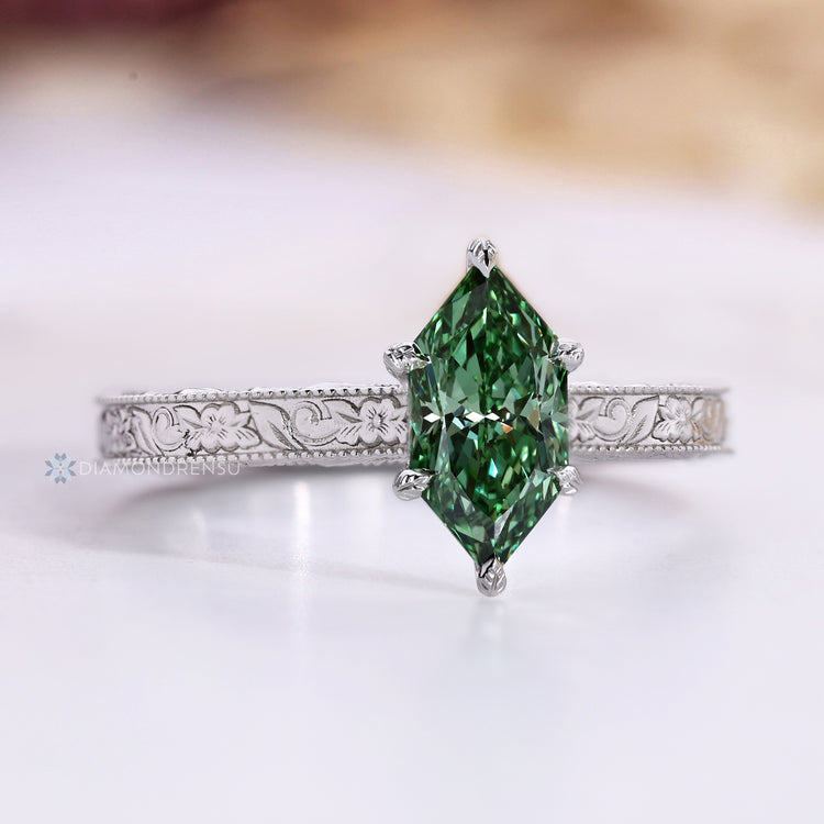 Nature inspired Dutch marquise diamond ring with a green stone.