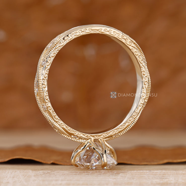Cushion cut diamond ring with a twisted shank and round stones.