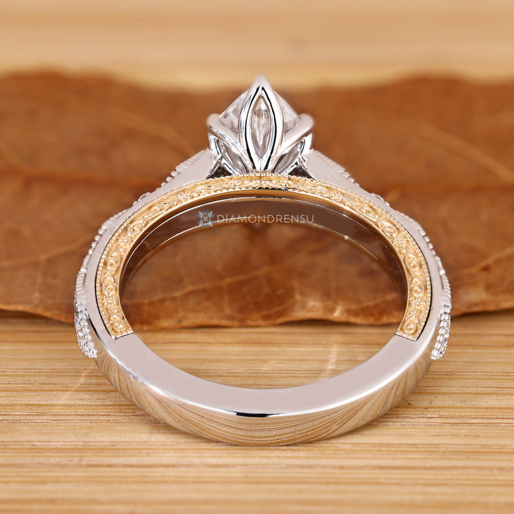 Dutch marquise ring with milgrain details and round and marquise accents.