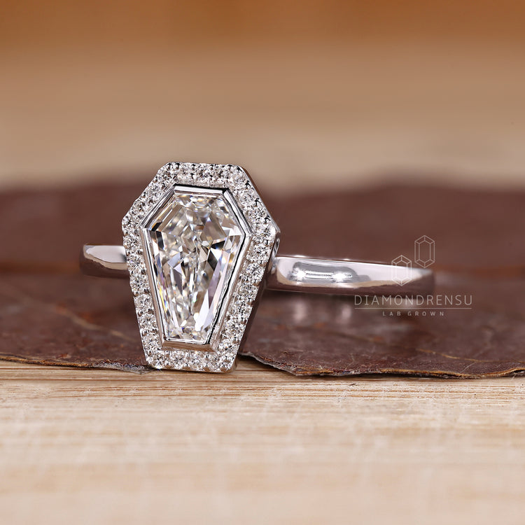 Diamondrensu coffin ring with lab grown diamond center stone.